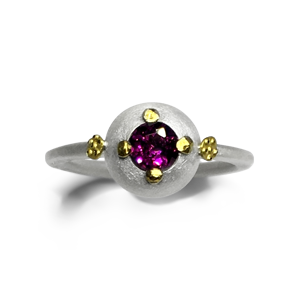 The colour of the Rhodolite garnet is a rich regal mulberry colour the rosettes are pure gold, the band is sterling silver